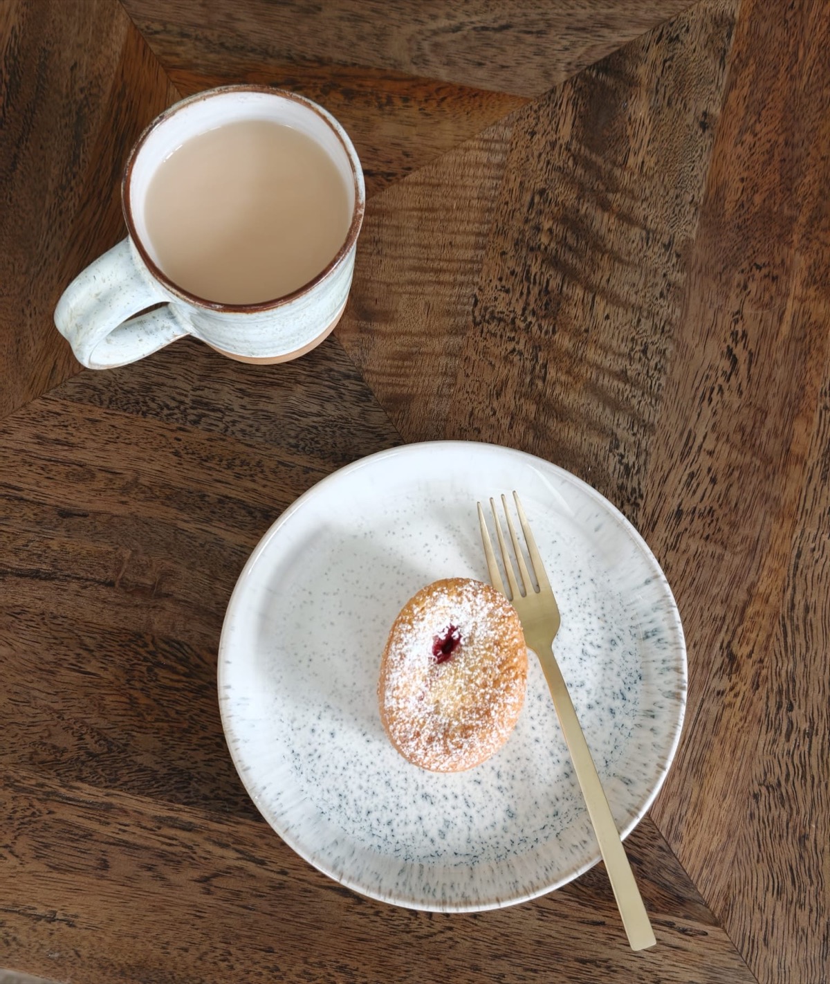 A friand and a cup of tea on the table by the window