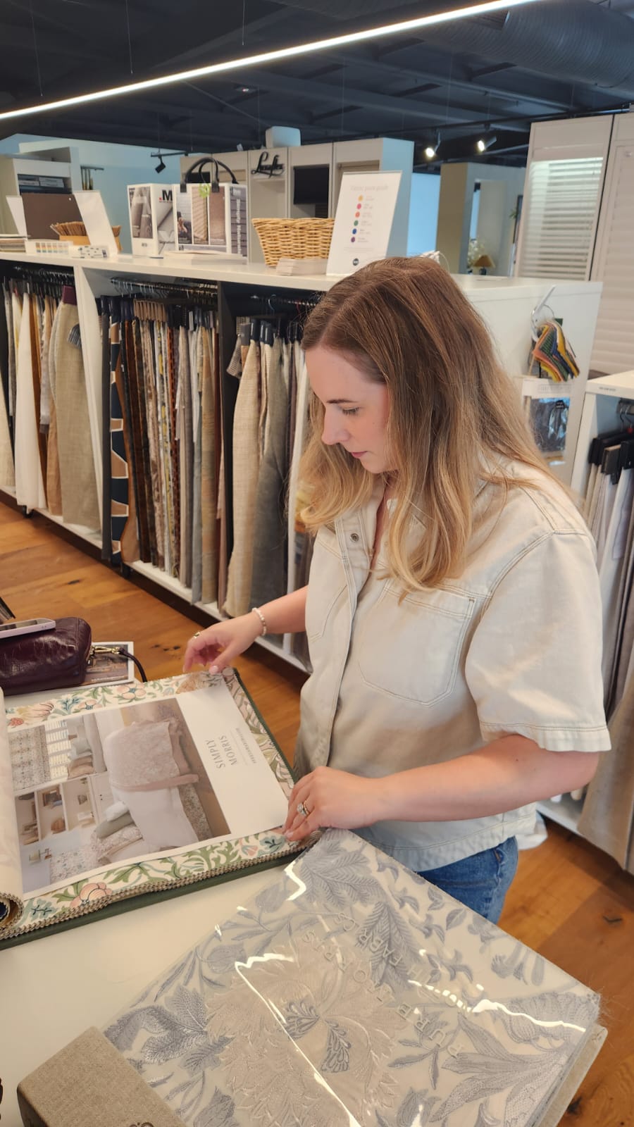 side Among the sample books at McKenzie & Willis